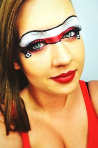 Close-up portrait of female soccer fan with polish flag face paint