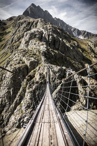 Footbridge against mountains