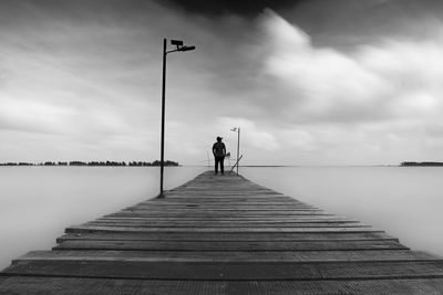 Forever alone a man in front of jetty fine art photography