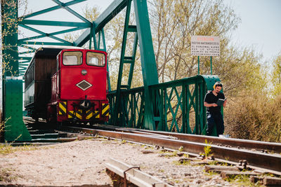 Man standing by train on railroad track