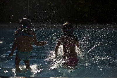Girls wading in swimming pool