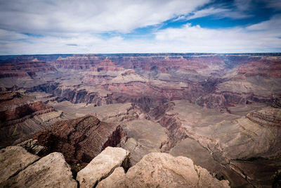 Scenic view of dramatic landscape against cloudy sky