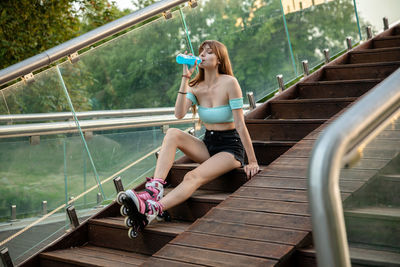 Low angle view of woman sitting on staircase