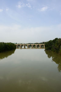 Bridge over lake against sky