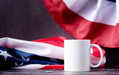 Cropped hand of woman holding american flag