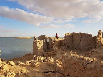 Rocks on beach against sky