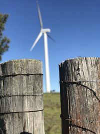 Wooden post on fence against clear sky