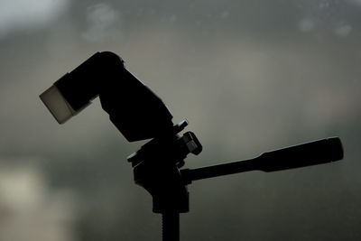 Low angle view of photographer photographing against sky