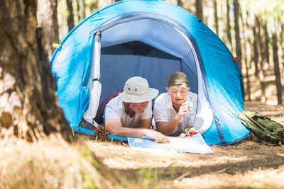 Men sitting in tent