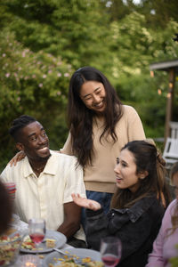 Smiling friends enjoying picnic