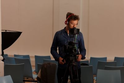 Photographer operating digital camera in studio
