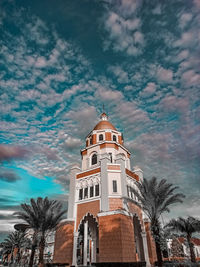 Low angle view of building and trees against sky