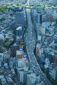 Aerial view of road amidst buildings in city