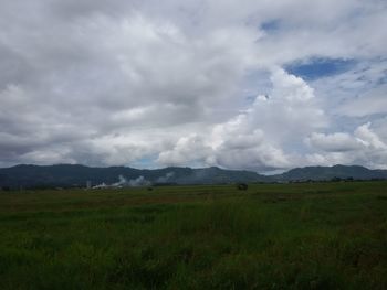 Scenic view of landscape against cloudy sky