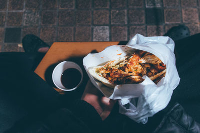 High angle view of person  eating kebab