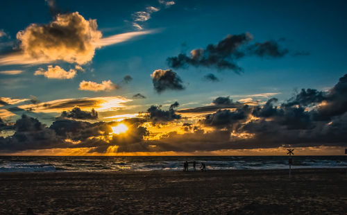 Scenic view of beach against sky during sunset