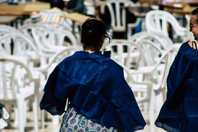 Rear view of people standing in factory