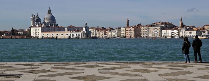 Panoramic view of santa maria della salute in front of canal on sunny day