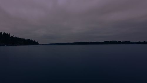 Scenic view of lake against sky at sunset