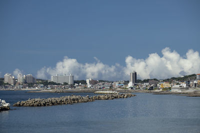 Panoramic view of sea and buildings against sky