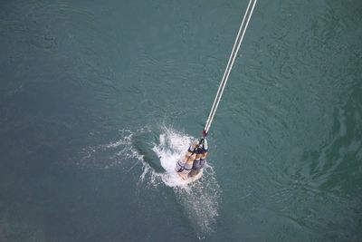People bungee jumping in sea