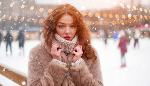 Portrait of woman standing outdoors during winter