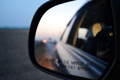 Close-up of cropped car on road