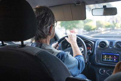 Rear view of man driving car