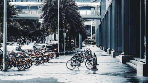 Bicycle parked on street by building