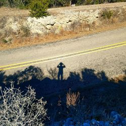 High angle view of person shadow on road
