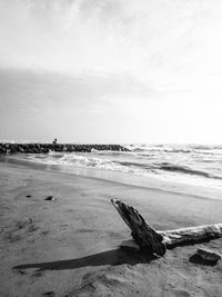 Scenic view of sea against sky with timber