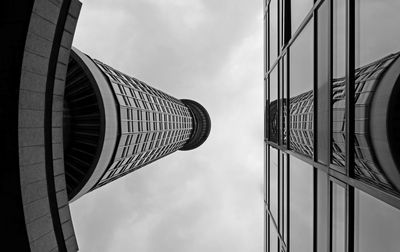 Low angle view of modern building against cloudy sky