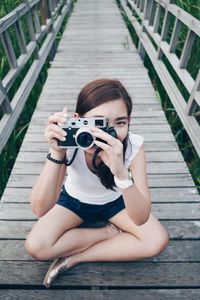 Portrait of woman photographing