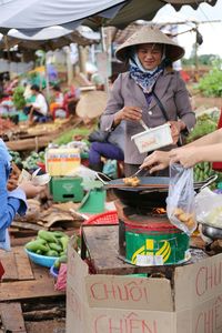 Midsection of woman for sale at market stall