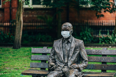 Statue on bench in park