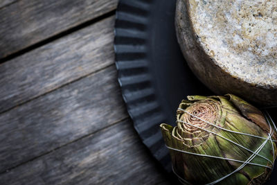 High angle view of snail on wooden table