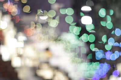 Defocused image of illuminated christmas lights at night