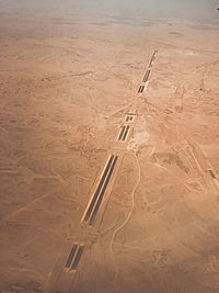 Airplane flying on sand at beach