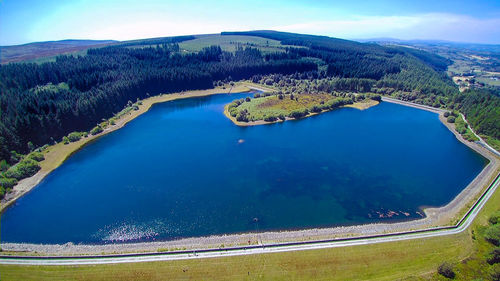 High angle view of swimming pool by lake against sky