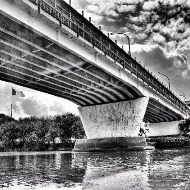 built structure, architecture, connection, water, bridge - man made structure, sky, river, cloud - sky, waterfront, building exterior, bridge, cloudy, low angle view, engineering, reflection, tree, cloud, transportation, footbridge, day