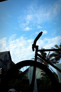 Low angle view of silhouette bicycle against sky