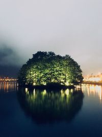 Scenic view of lake by trees against sky