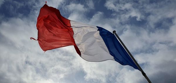 Low angle view of flag against sky