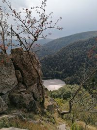 Scenic view of river by mountains against sky