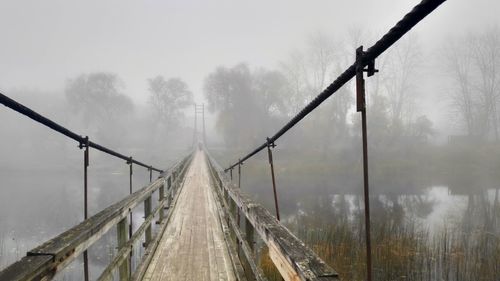 Panoramic view of footbridge during foggy weather