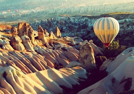 landscape, scenics, tranquil scene, nature, tranquility, beauty in nature, flying, mountain, sunlight, day, hot air balloon, outdoors, idyllic, travel, water, sky, aerial view, non-urban scene, transportation, field