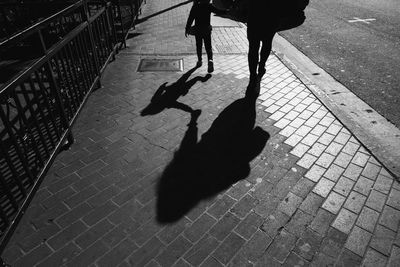 High angle view of silhouette man walking on floor