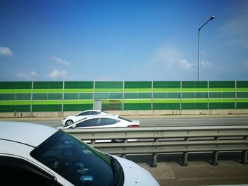 Cars on road against sky