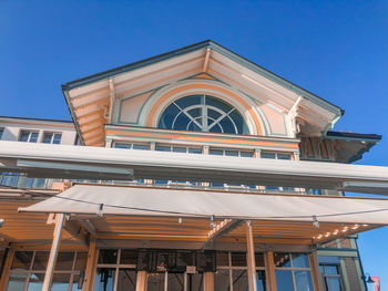 Low angle view of building against clear blue sky