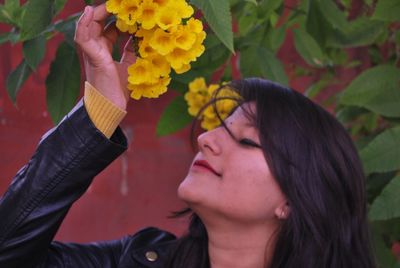 Close-up of woman and yellow flowering plants